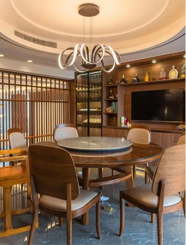 dining table Modern dining area with round table, designer chairs and pendant lighting