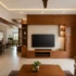 Handcrafted solid wood wardrobe and cabinet unit with natural wood grain, paneled doors, drawers, open shelving, and soft daylight from a nearby window.